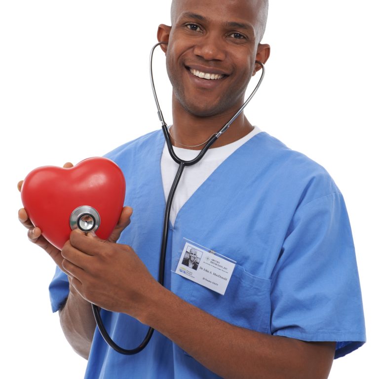 A doctor holding a heart prop in his hands